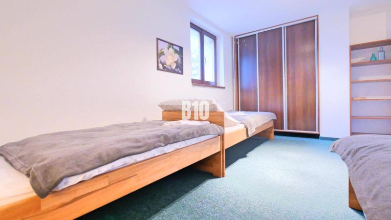 A bedroom in a three-room apartment with two beds and a built-in wardrobe.