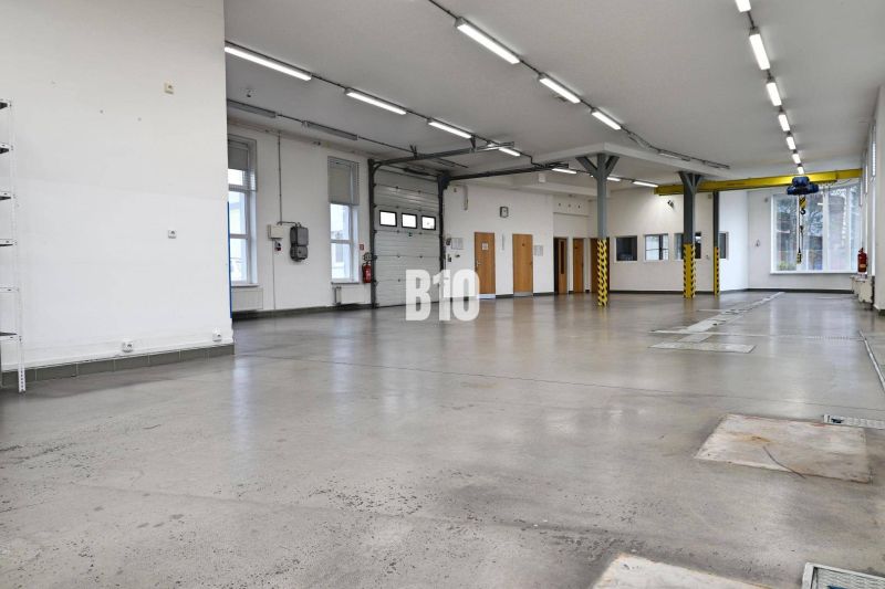 Bright production spaces with concrete floors and high ceilings.