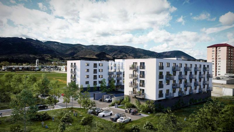 A new building on Košútska Street in Martin surrounded by greenery and mountains.