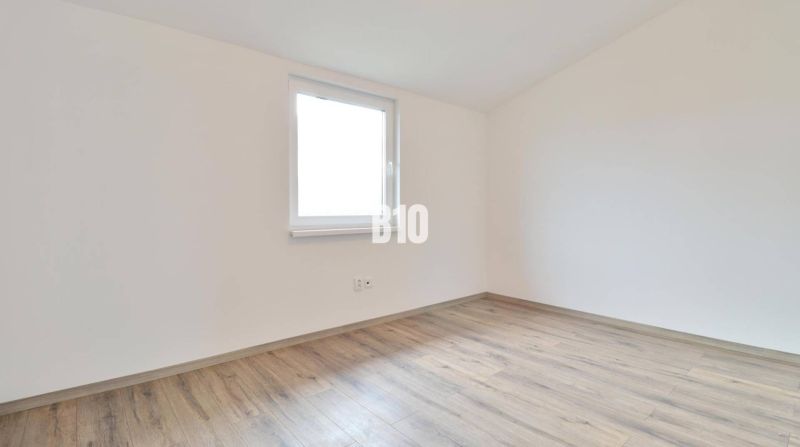 An empty room with a wooden floor in a family house.