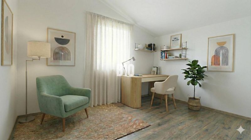 A study in a family house with an armchair, a desk, and a floor with a wooden decor.