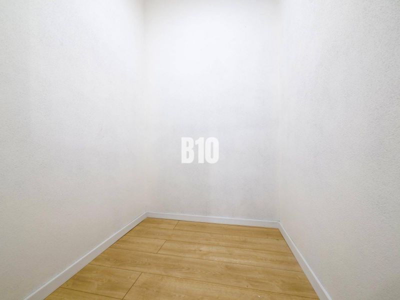 Storage space with a wooden decor floor in a 3-room apartment.
