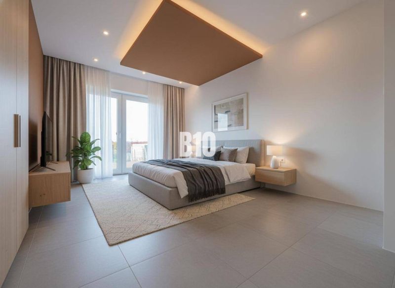 Bedroom in a family house with a large window, gray floor, and a plant.