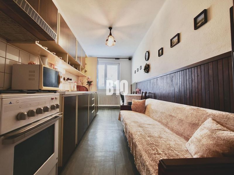 A cozy kitchen with a sofa and decorations in a 3-room apartment.