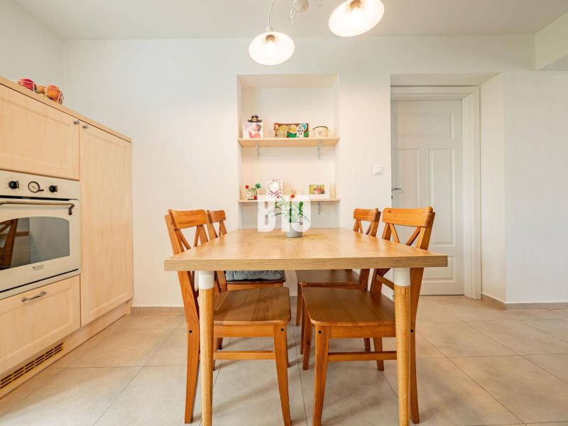 Dining room with a wooden table and chairs in a 3-room apartment.