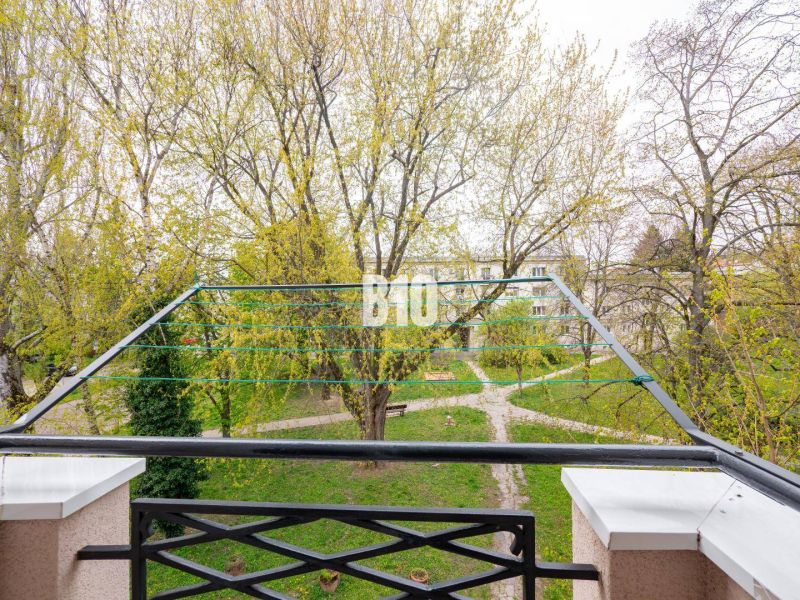 View from the balcony of a 3-room apartment in Nitra overlooking a green park with pathways.