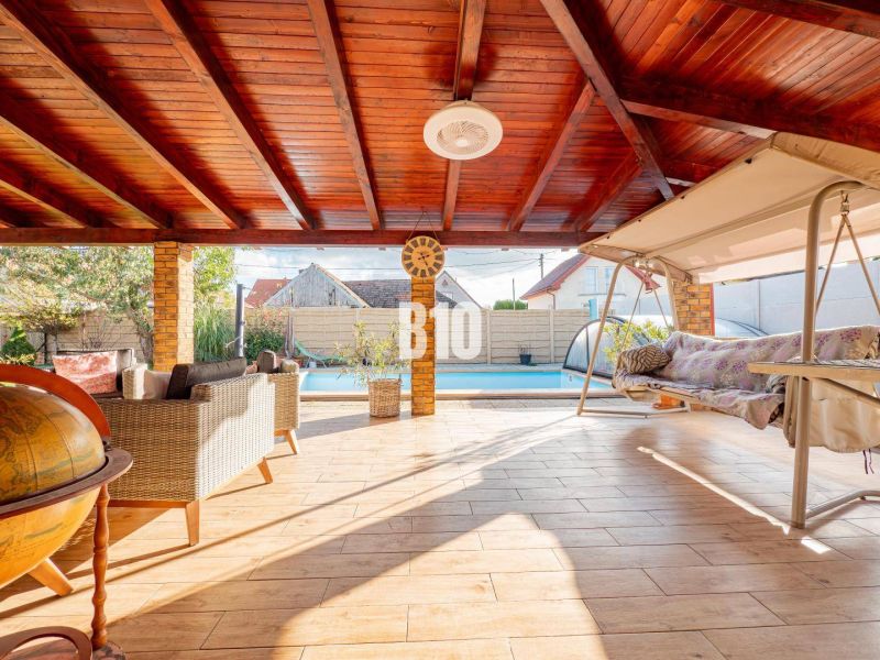 A spacious terrace in a family house in Nitra with a swimming pool and a swing.