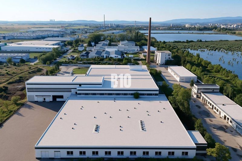 Production facilities in Levice surrounded by nature and a body of water.