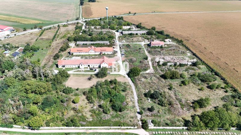 An area with buildings and nature surrounded by agricultural and forest lands in Levice.