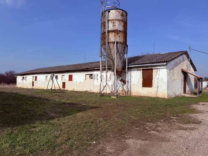 Production premises in the town of Turá with an extensive yard and older buildings in the background.