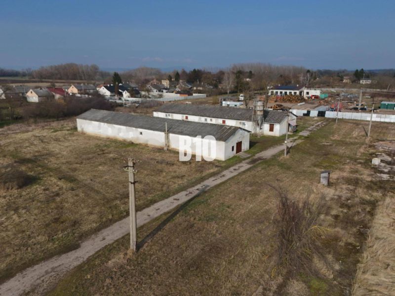 Production facilities in the town of Turá, surrounded by wooded and rural landscape.