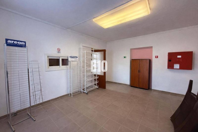 Commercial spaces with empty shelves and storage cabinets.