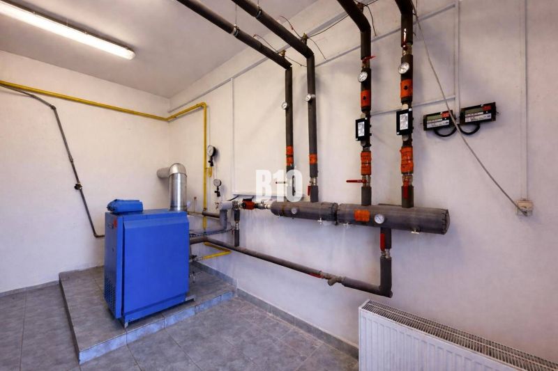 A boiler room with piping and meters in commercial premises.