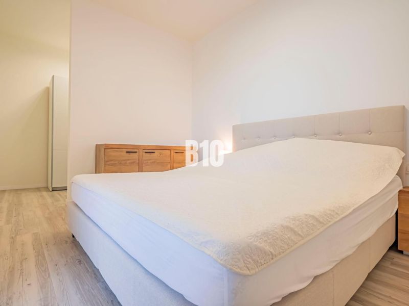 Bedroom with a bed, furniture, and flooring with wood decor, 3-room apartment.