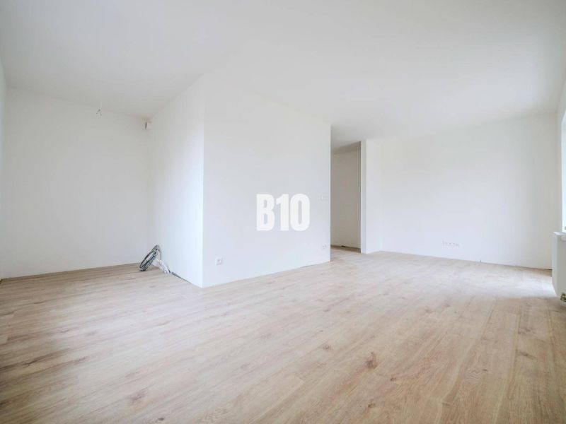 Bright and spacious 1-room apartment with new wooden flooring and clean walls.