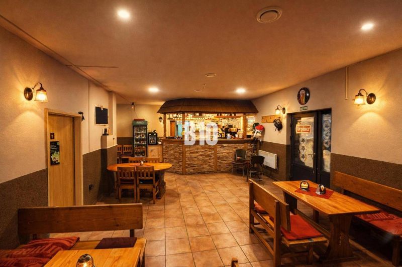 The interior of the building with wooden furniture and a bar, a pleasant atmosphere for sitting.