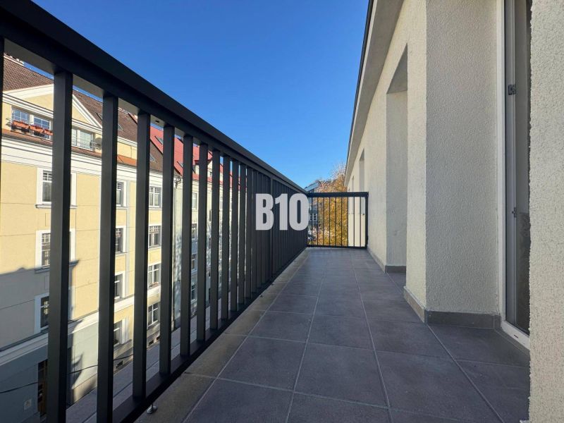 A balcony with a view of buildings in Žilina, suitable for a 2-room apartment.