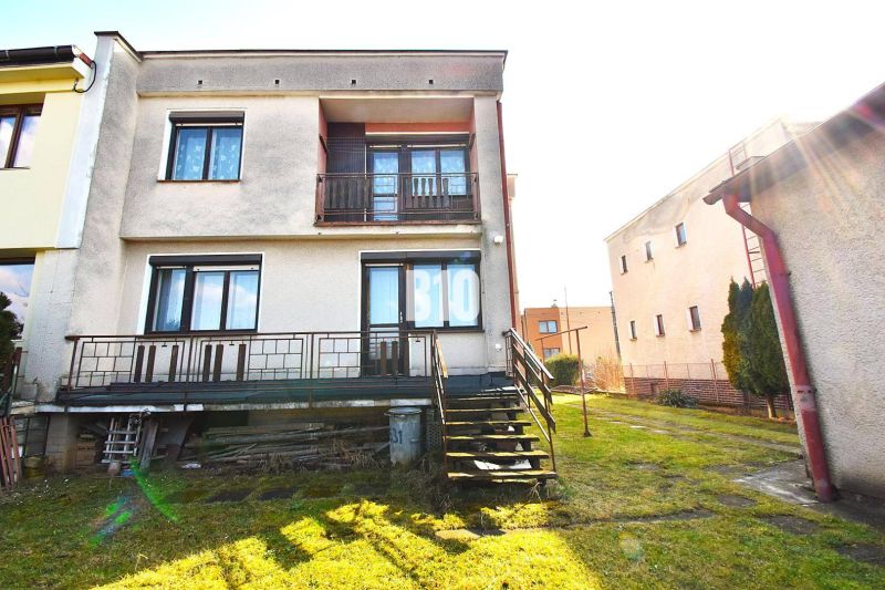 A family house in Žilina with a terrace, lawn, and stairs leading to the garden.