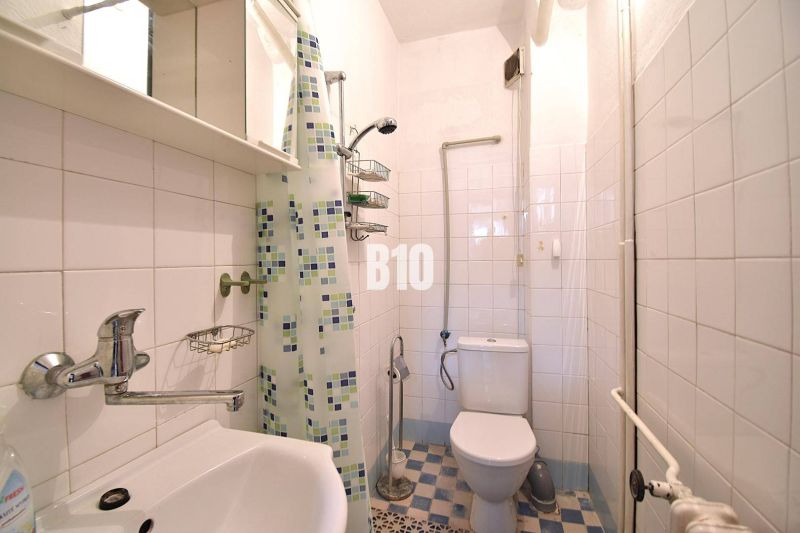A bathroom in a family house with tiles and a shower corner.