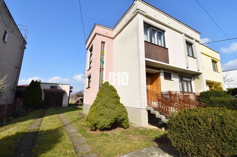 A family house in Žilina with a garage, garden, and driveway in a quiet neighborhood.