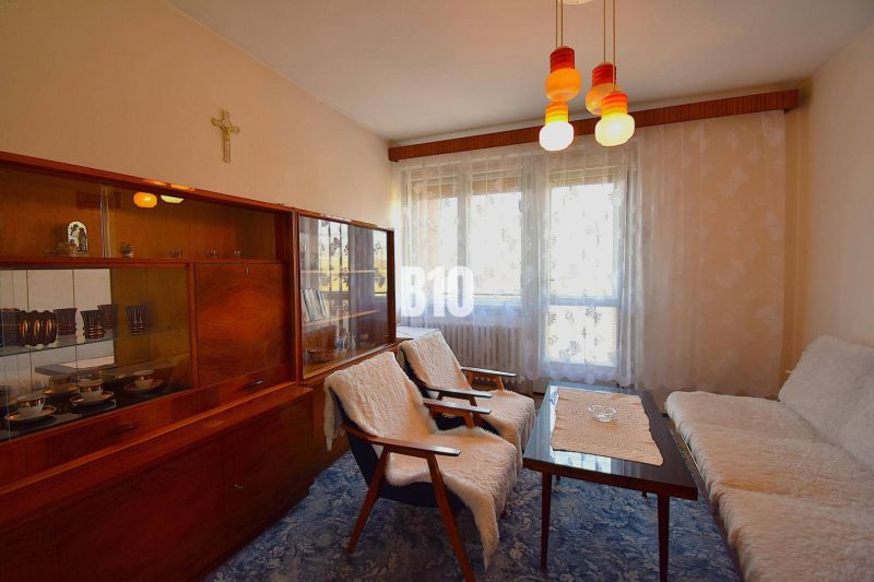 Living room in a family house with retro furniture and curtains on the window.