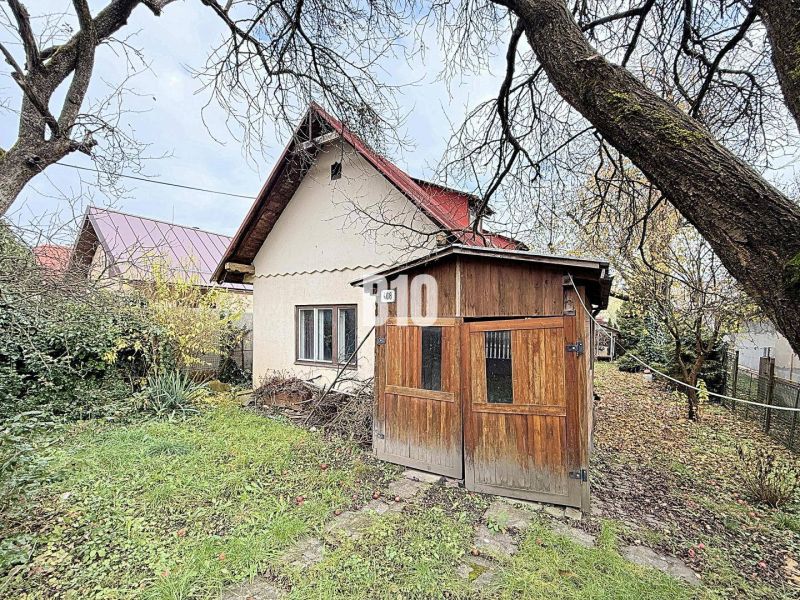 A family house in Kotešová with a wooden shelter and a garden in the autumn season.