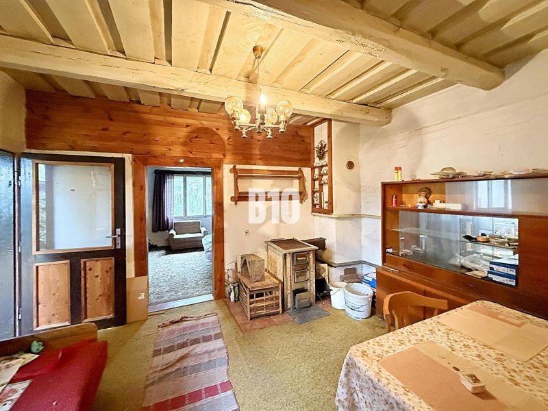 Interior of a family house with traditional furnishings, tiles, carpets, and wooden decor.