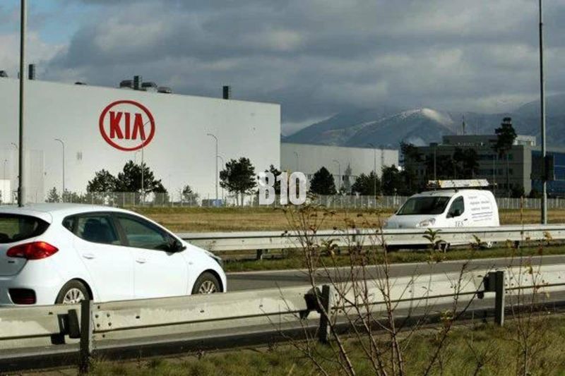 KIA Motors plant in Slovakia, cars on the highway, commercial land in the background.