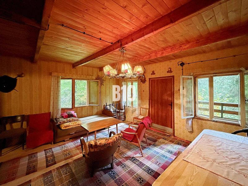 Rustic interior of a cottage with comfortable furniture and a wooden decor floor.