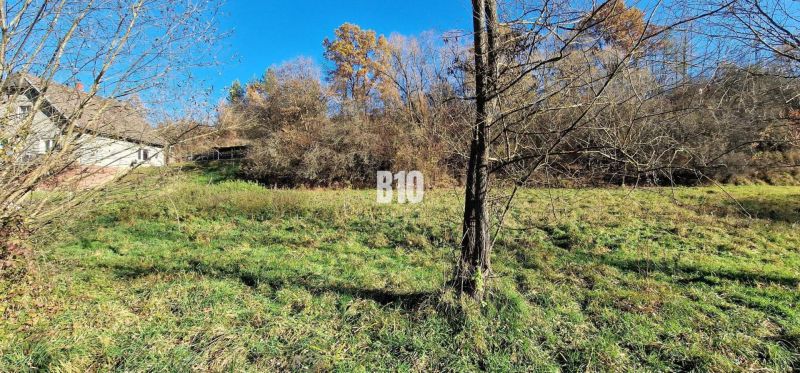 Extensive residential plots in Bytča, surrounded by trees with a property in the background.