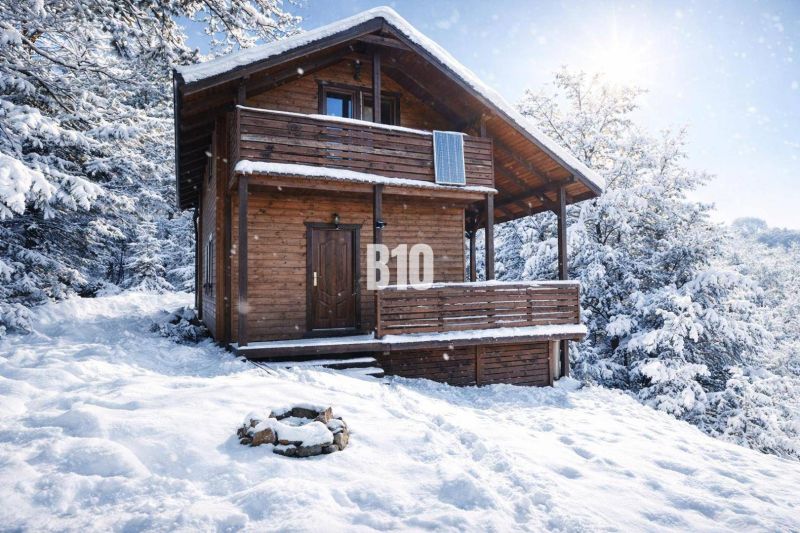 A snowy wooden cabin in Bytča surrounded by forests.