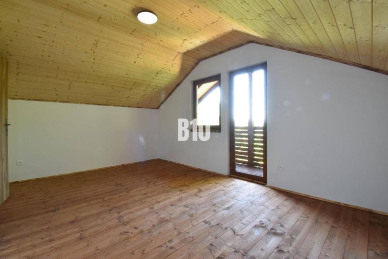 Attic room with wooden paneling and flooring in the Cottage near Bytča.