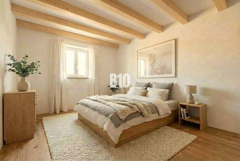 Interior of a cabin with wooden beams, a comfortable bed, and a floor with a wooden decor.