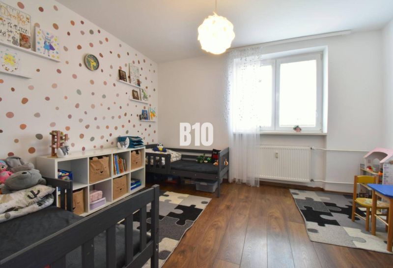 A children's room with a wooden decor floor in a 3-room apartment.