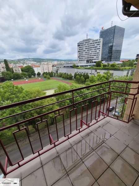 View from the balcony on Jelačičova in Bratislava - Ružinov with a high-rise building in the background.