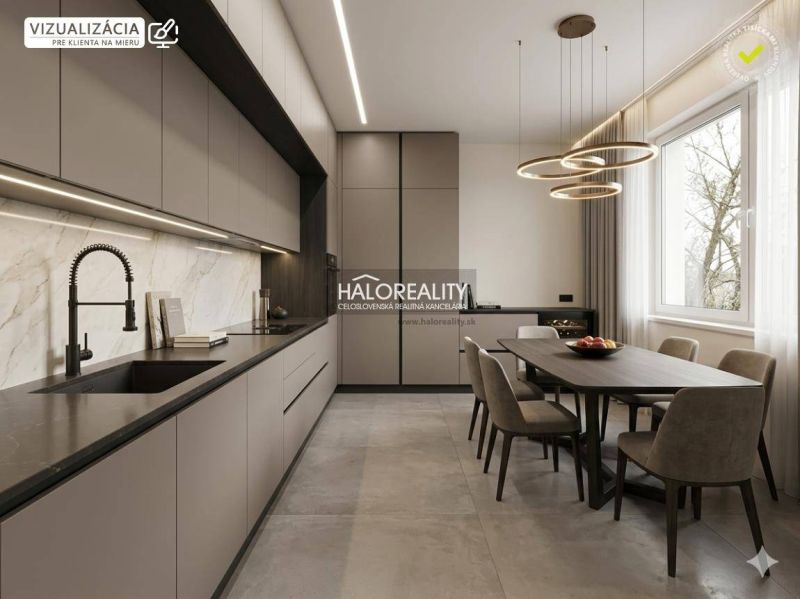 A kitchen in a studio apartment with modern lighting and a dining table for six people.