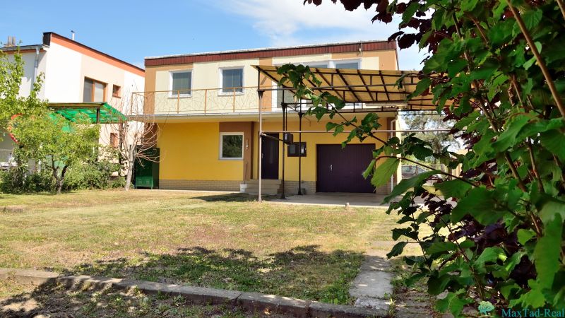 Yellow family house with a garage and terrace on Nabr. J. M. Hurbana Street in Michalovce.