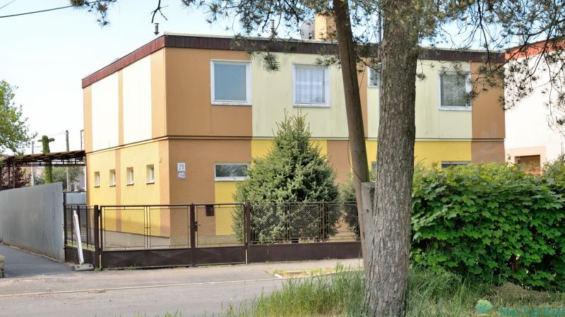 A family house on Nabr. J. M. Hurbana in Michalovce, surrounded by greenery with a fence.