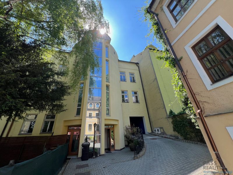 A building with a glass facade on a narrow street, Grösslingova, Bratislava - Old Town. Offices.