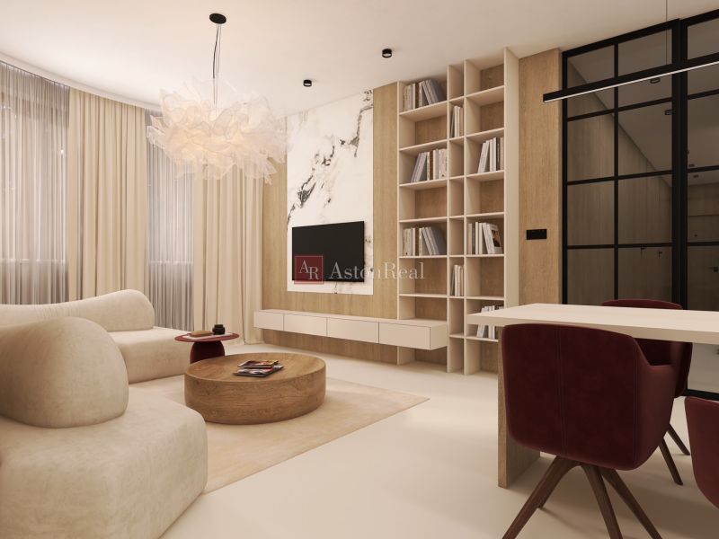 Living room in a two-room apartment with a comfortable sofa and a bookshelf.