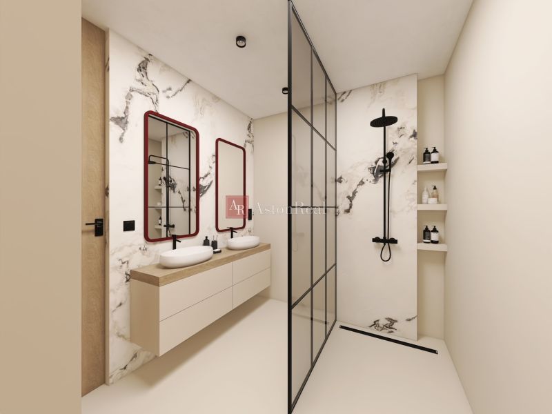 A bathroom in a 2-room apartment with a shower and two sinks.