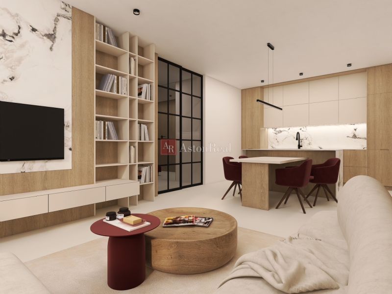2-bedroom apartment with a library, marble decor, and a kitchen with red chairs.