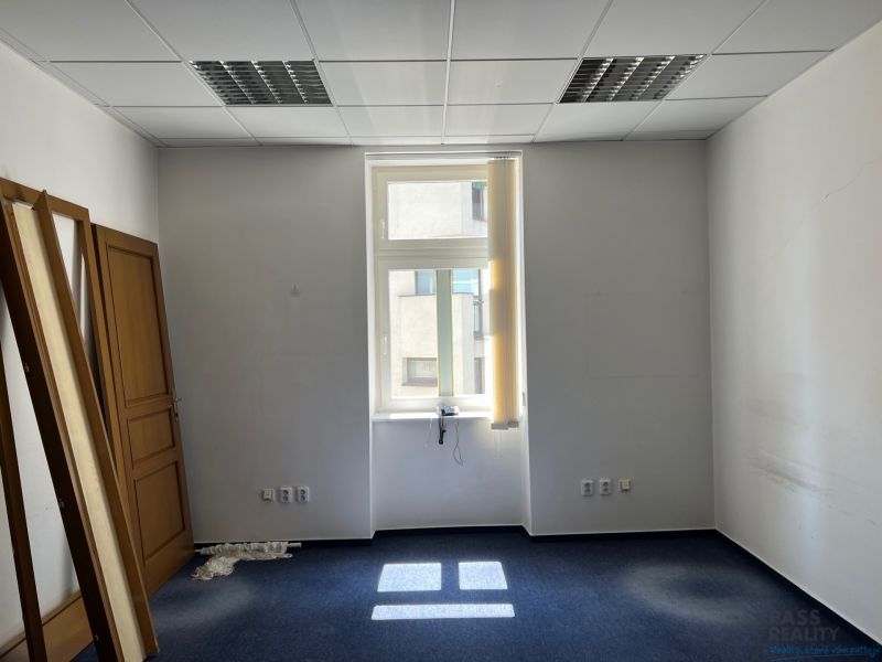 Offices with blue carpet and doors leaning against the wall.