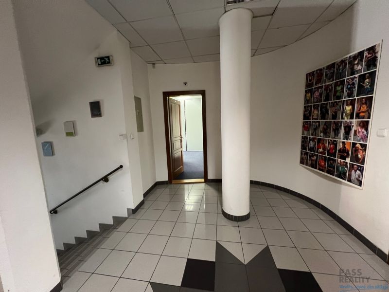A hallway in offices with stairs and wall decoration.