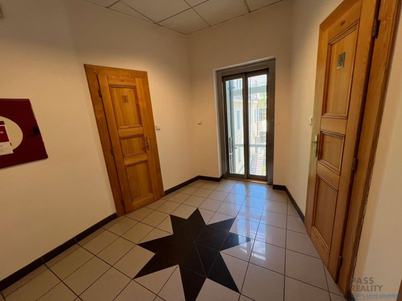Offices with wooden doors, star-patterned tiles, and glass doors.