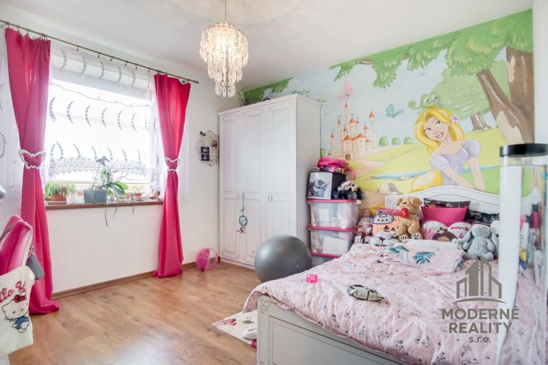 Children's room in a family house with princess decor and wooden floor decor.