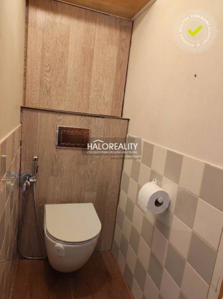 Bathroom in a 3-room apartment with a wooden decor floor and tiling.