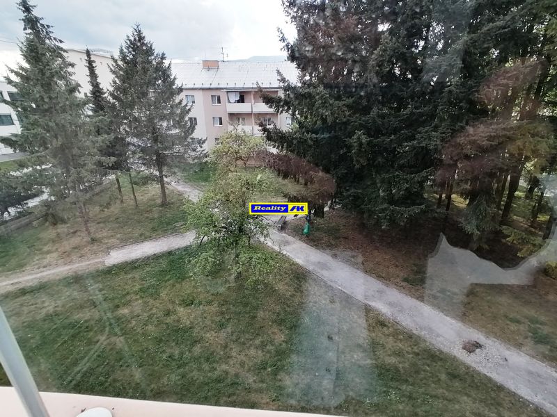 View of greenery and a block of flats from a 1-room apartment on Záborského Street in Martin.