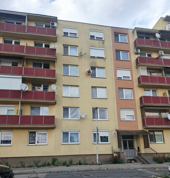 Apartment building on Nábrežná Street in Nové Zámky with red balconies.