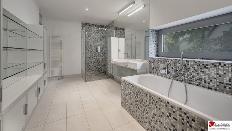 Bathroom with a bathtub, shower corner, and glass shelves in a 3-room apartment.
